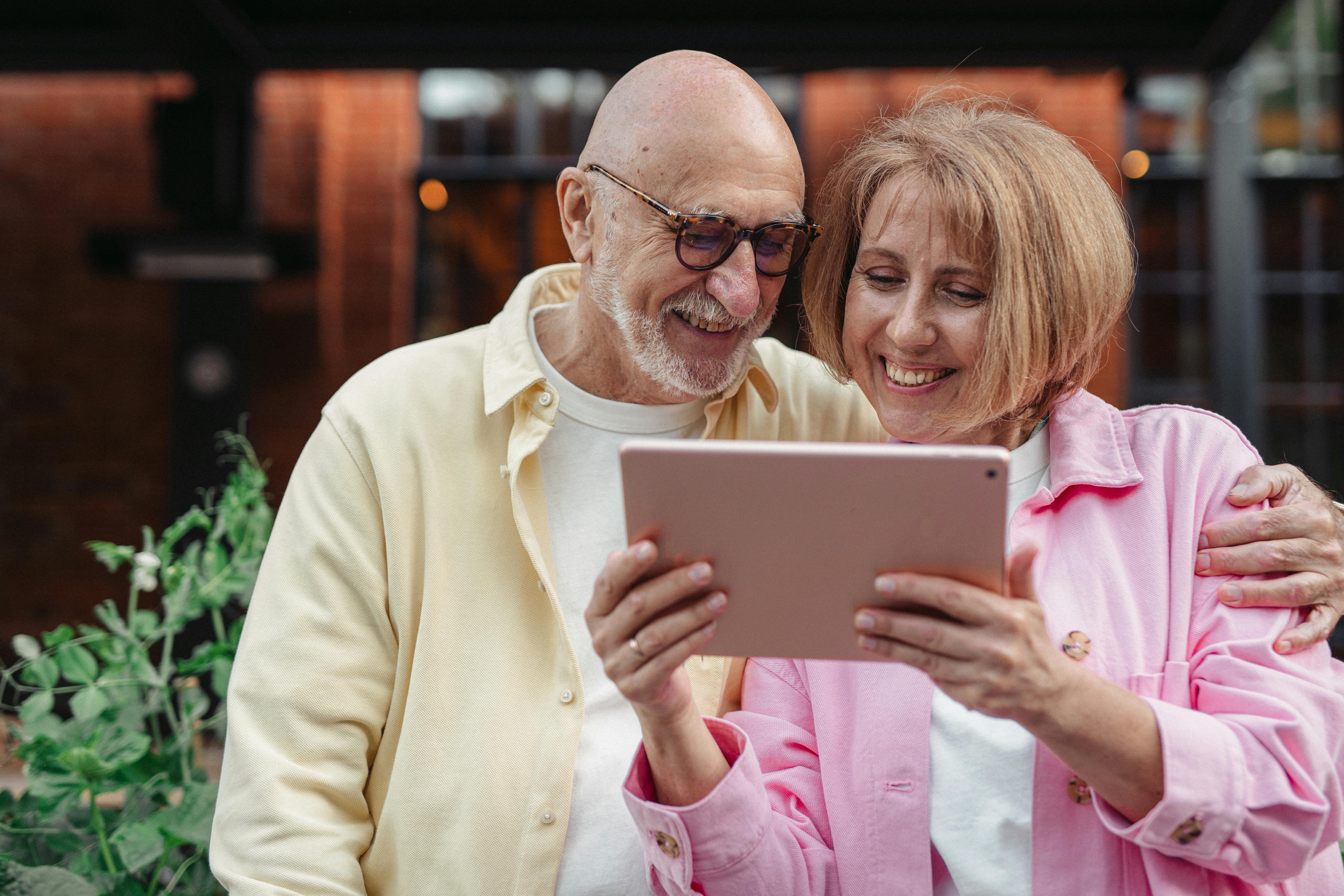 Happy couple reviewing Medicare options with an agent